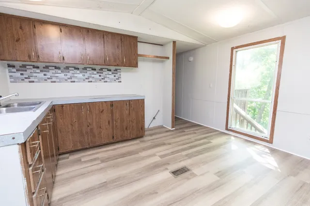 a view of a kitchen with a sink and a stove top oven