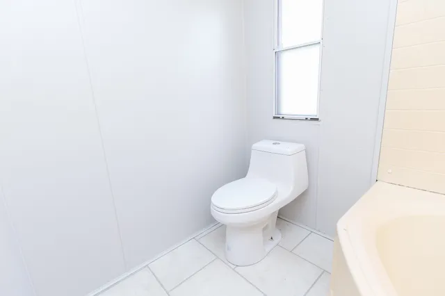 a white toilet sitting next to a white sink