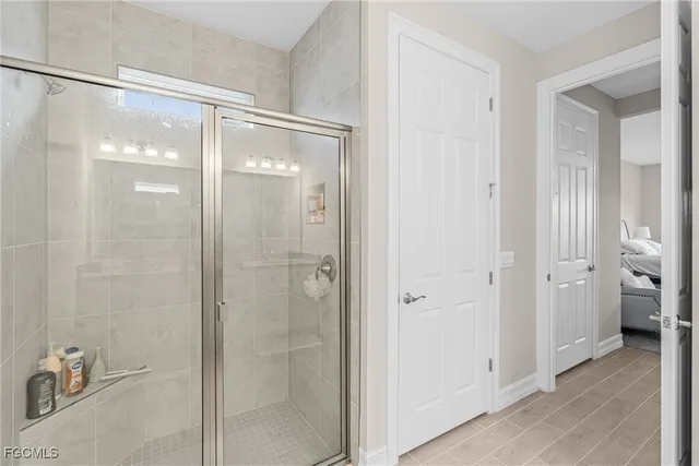 a bathroom with a glass shower door