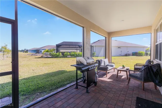 a view of a patio with lawn chairs floor to ceiling window and an ocean view