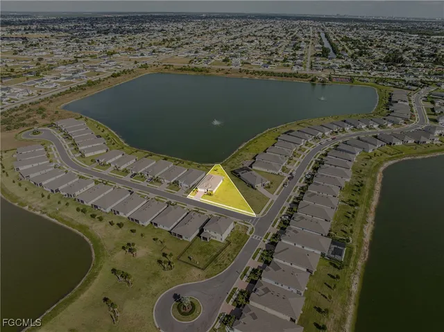an aerial view of a house with a lake view