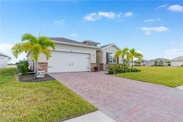 a front view of house with yard and green space