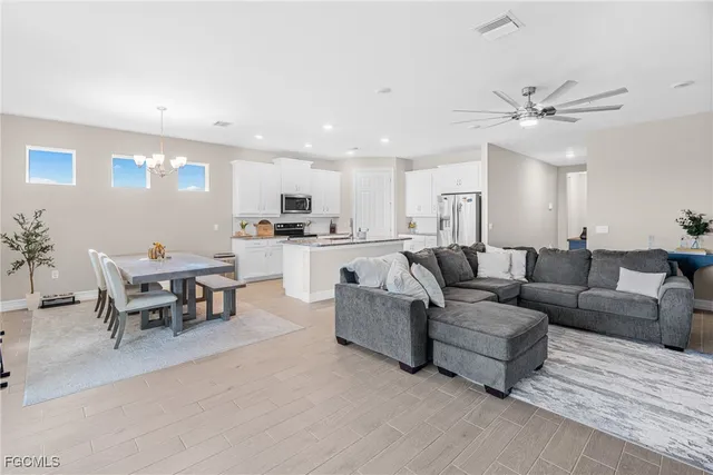 a living room with furniture kitchen view and a dining table