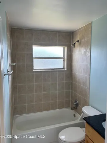 a bathroom with a toilet a sink and bathtub