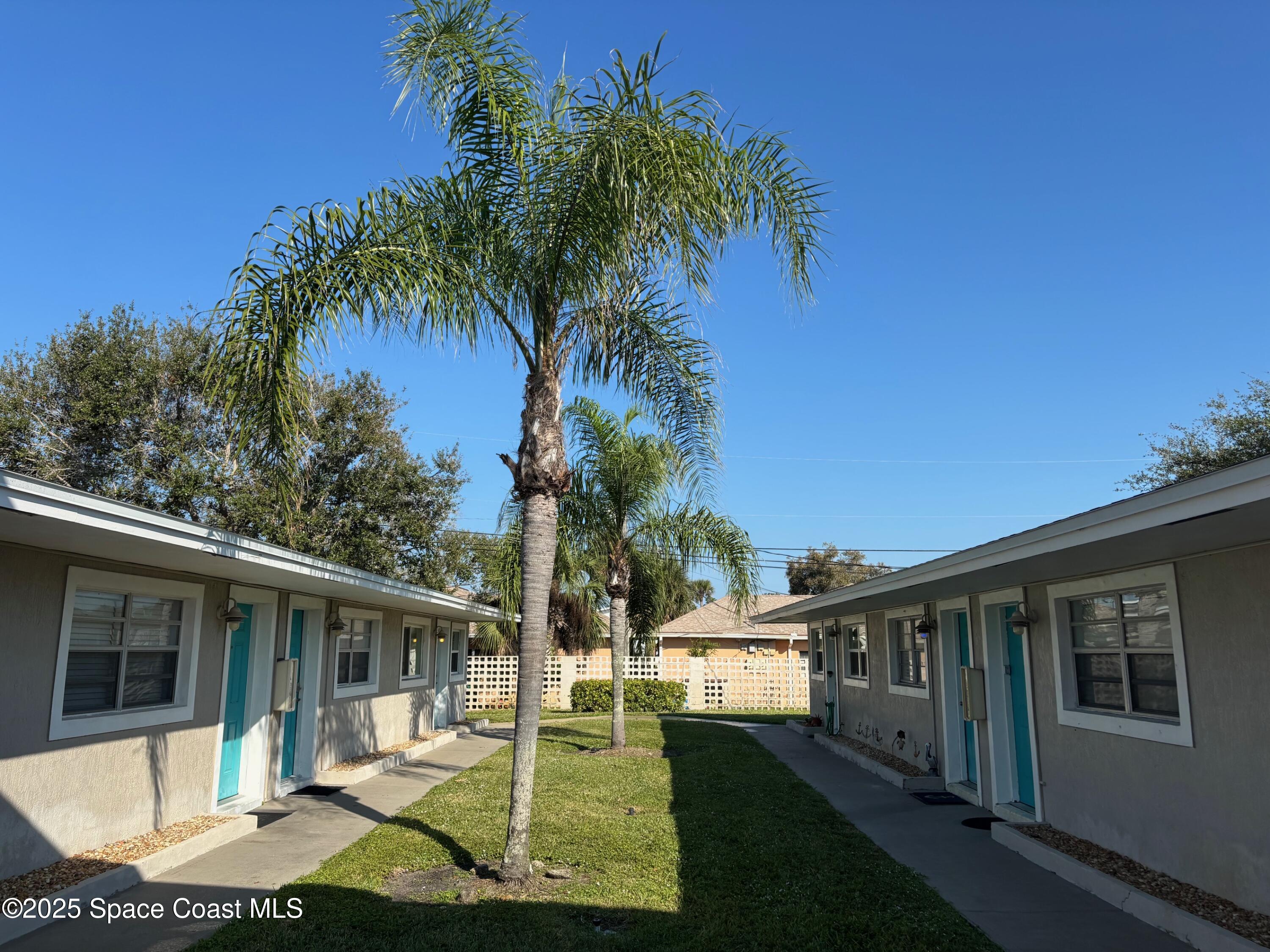 306 Johnson Avenue, Unit 5 Cape Canaveral, FL 32920 - Photo 5 of 17 a view of a house with a yard
