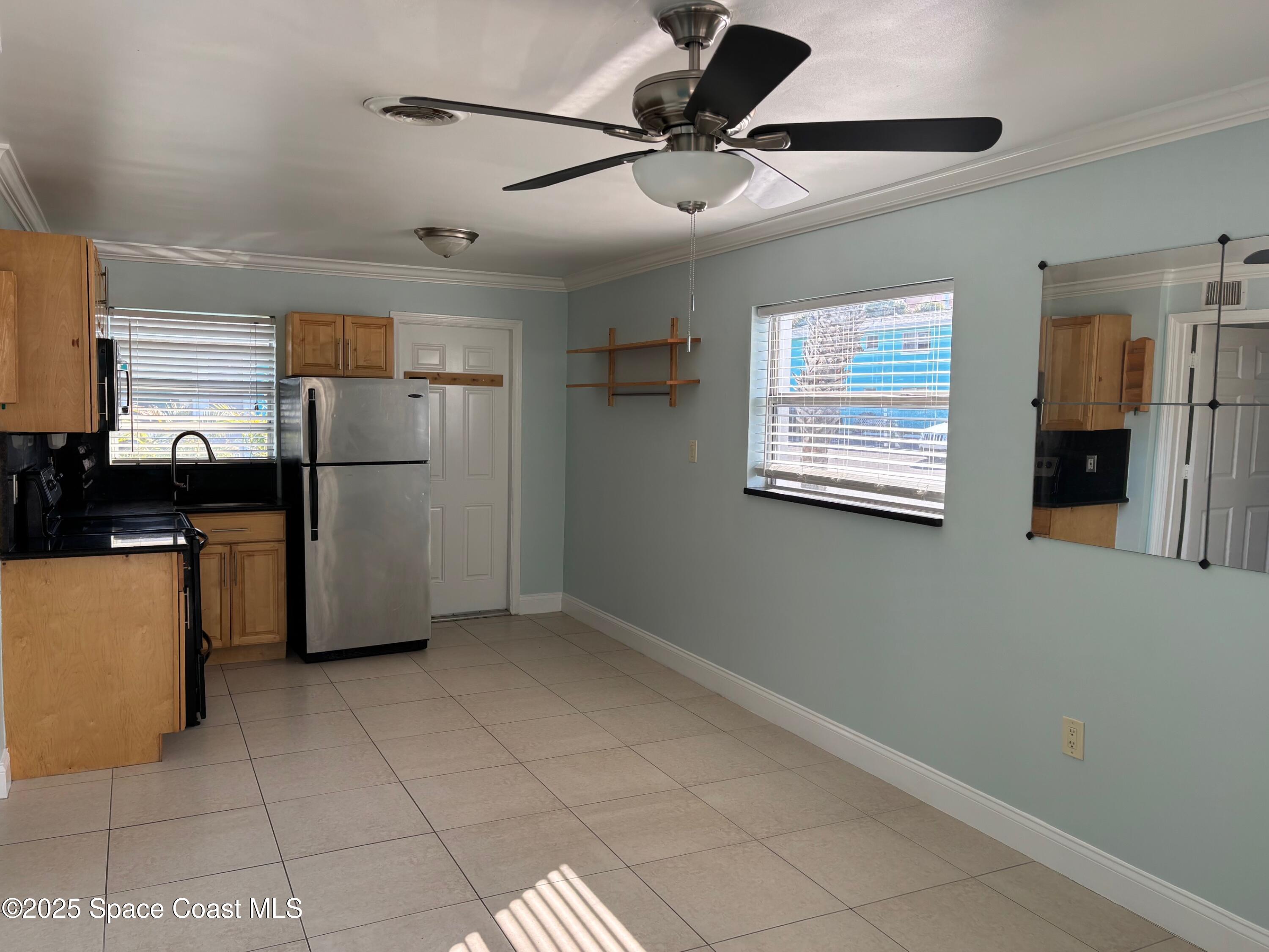 306 Johnson Avenue, Unit 5 Cape Canaveral, FL 32920 - Photo 8 of 17 a kitchen with stainless steel appliances granite countertop a refrigerator a sink a stove and cabinets