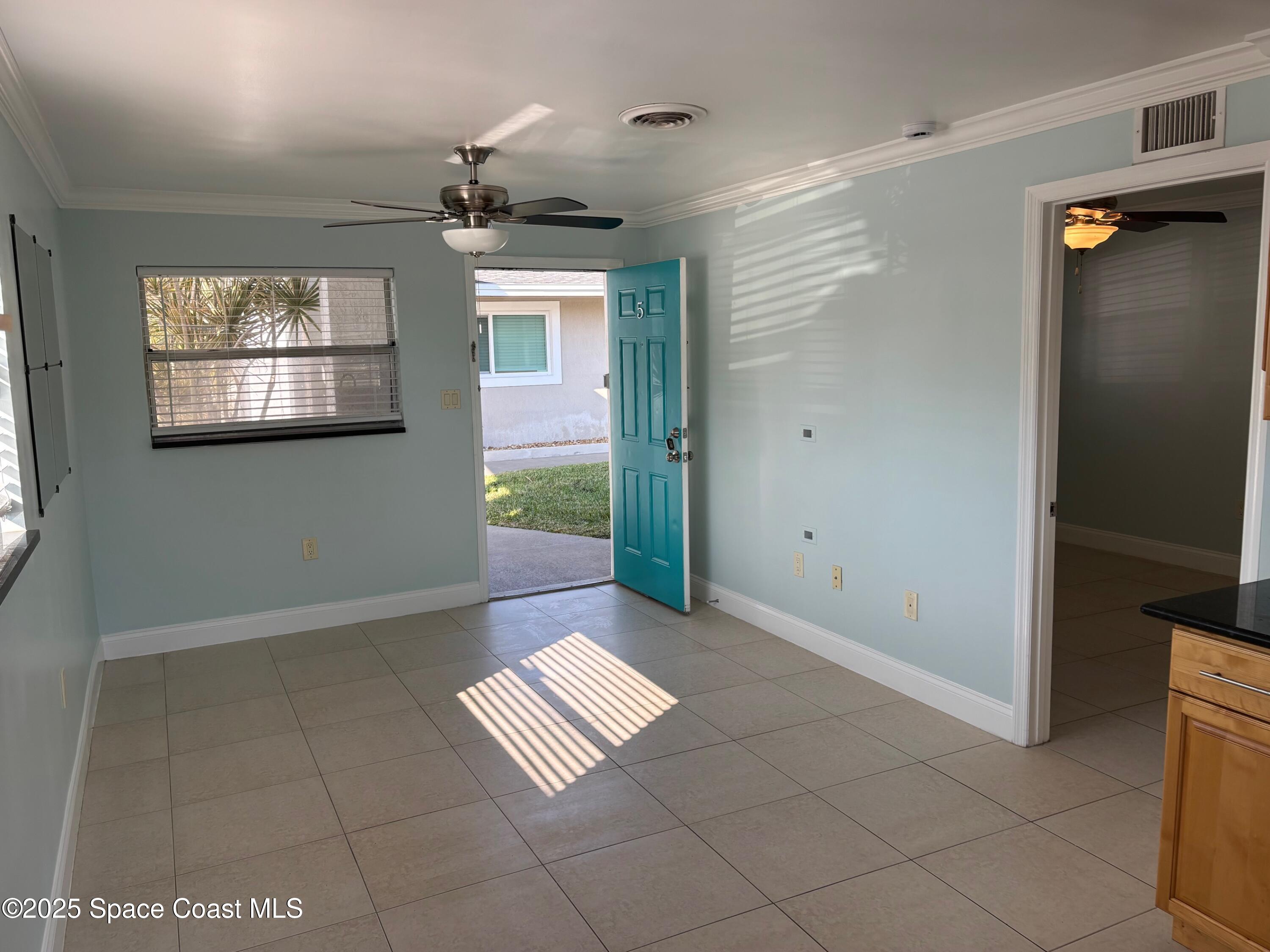 306 Johnson Avenue, Unit 5 Cape Canaveral, FL 32920 - Photo 10 of 17 a view of an empty room with a window