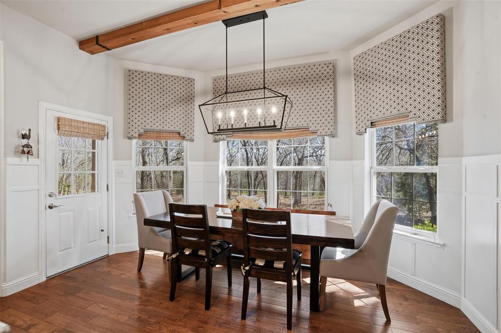 9651 Yellow Rose Lane Pilot Point, TX 76258 - Photo 17 of 38 a view of a dining room with furniture wooden floor and chandelier