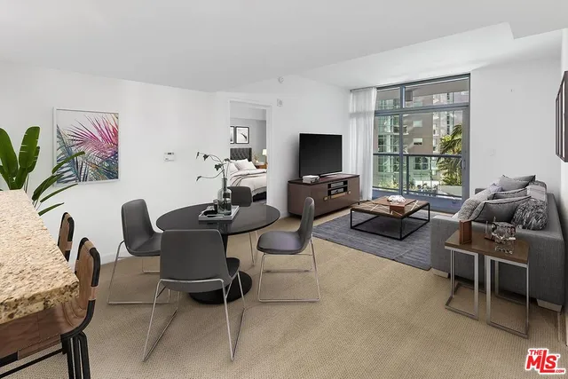 a living room with furniture a flat screen tv and a window