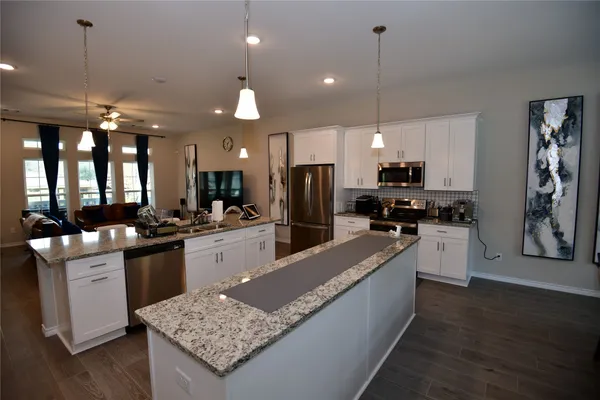 a large kitchen with kitchen island a large island in the center