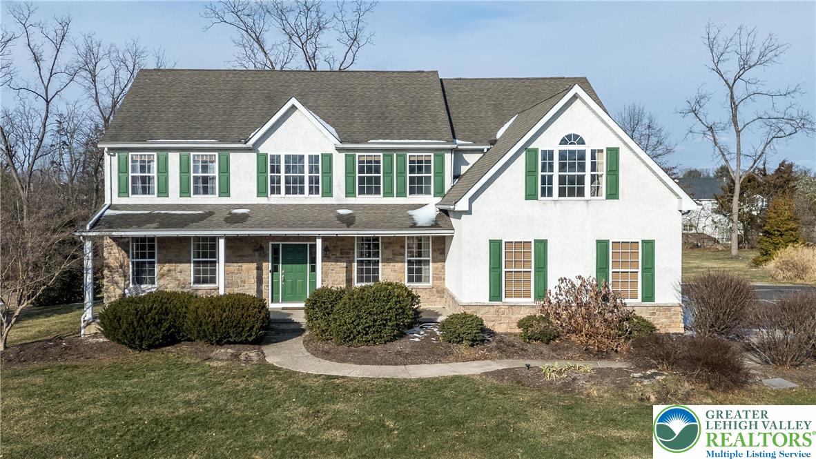a view of house with yard and sitting area