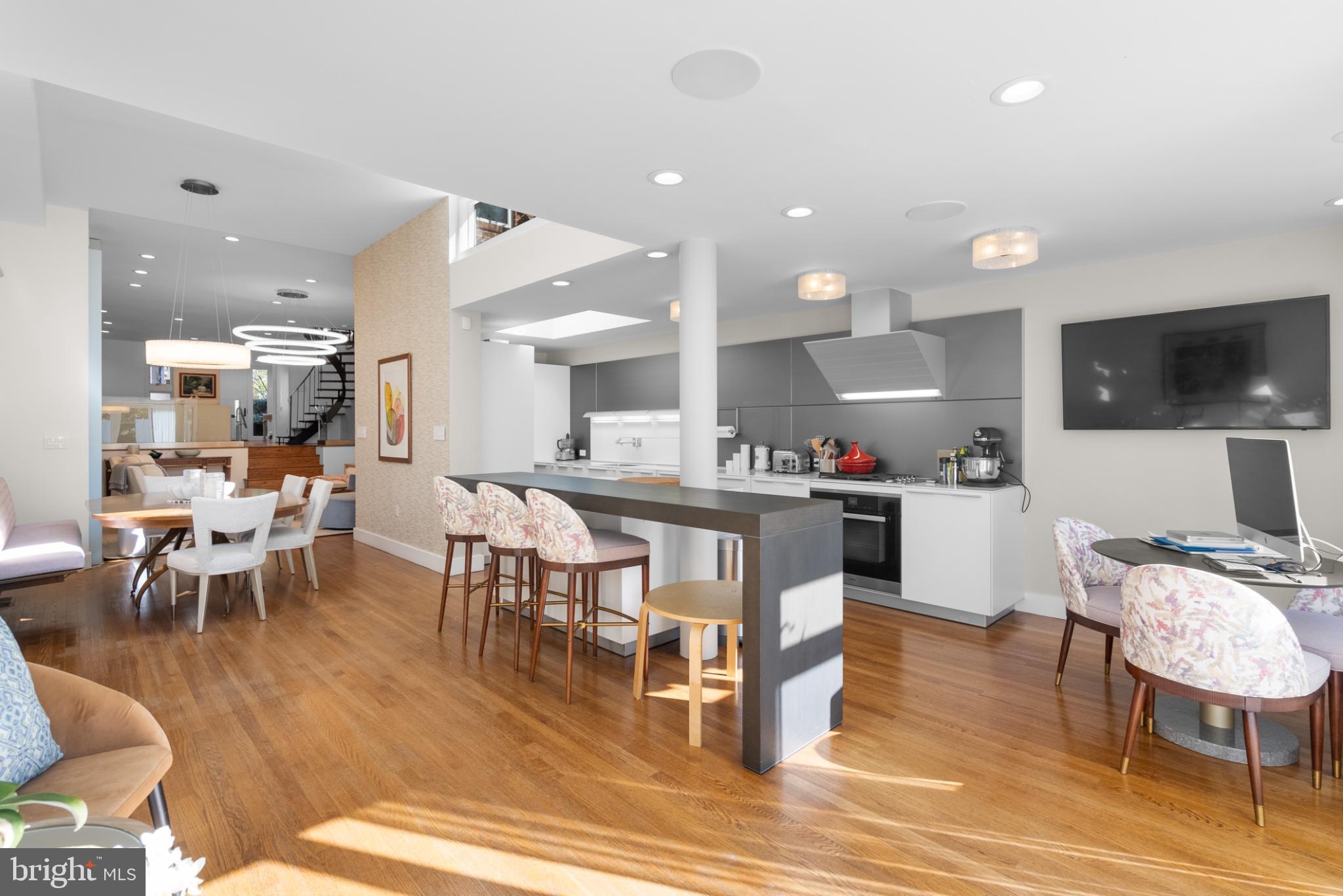 3322 Dent Place Northwest Washington, DC 20007 - Photo 17 of 41 a dining room with stainless steel appliances kitchen island granite countertop a table chairs and a microwave