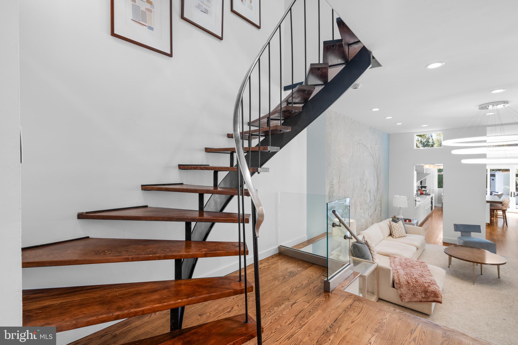3322 Dent Place Northwest Washington, DC 20007 - Photo 20 of 41 a living room with couches and a dining table with wooden floor