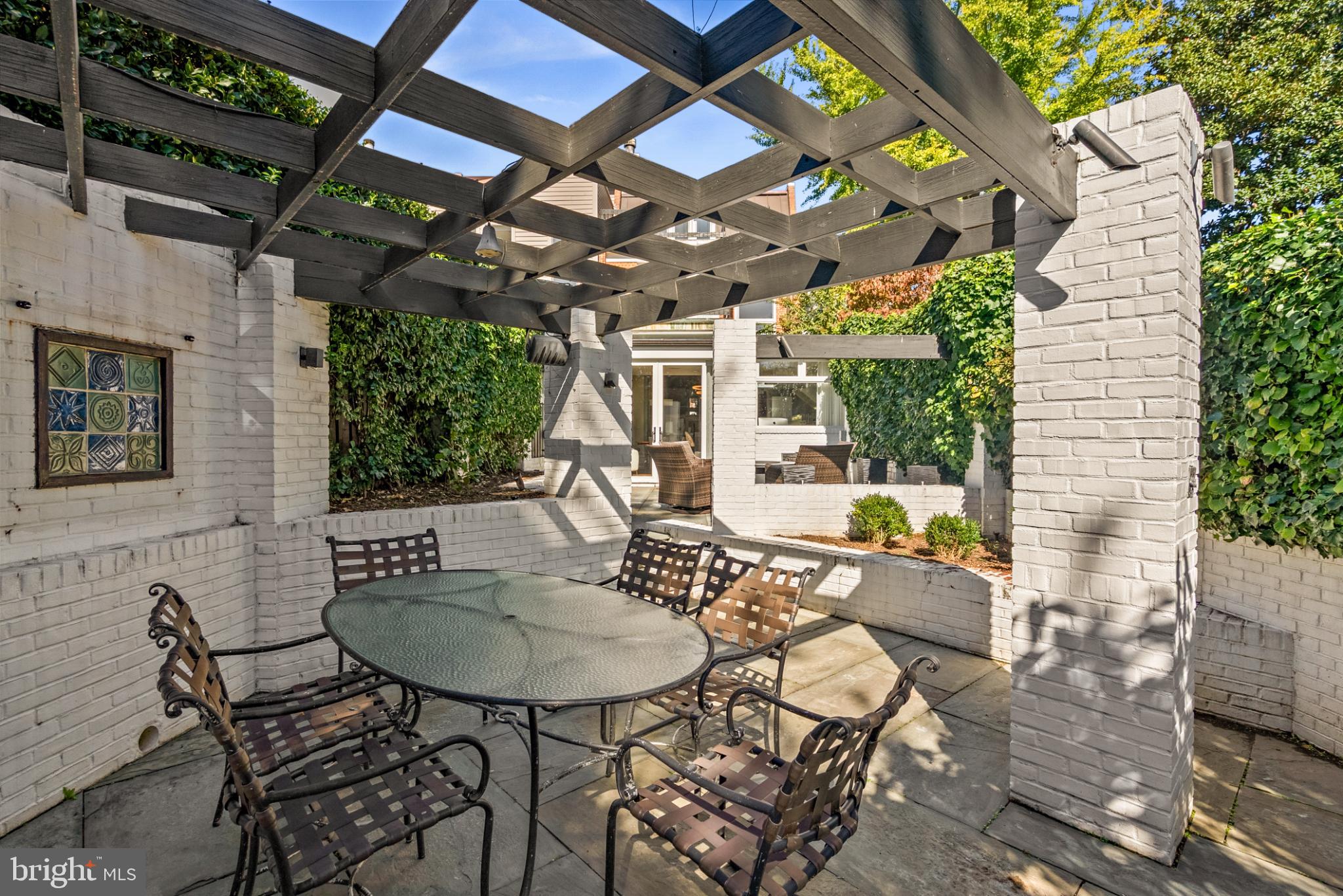 3322 Dent Place Northwest Washington, DC 20007 - Photo 38 of 41 a view of a patio with table and chairs with wooden floor and fence