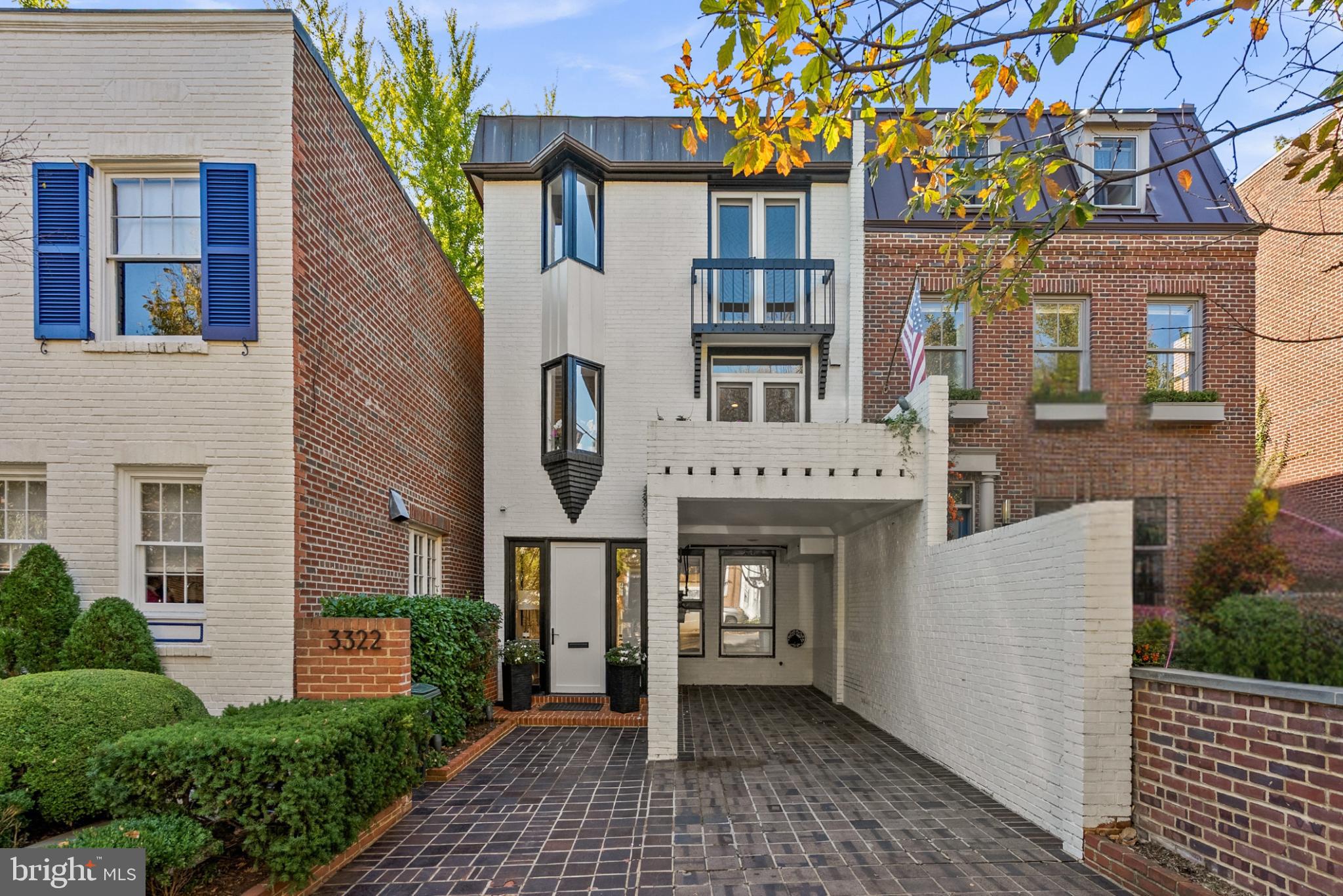 3322 Dent Place Northwest Washington, DC 20007 - Photo 40 of 41 a front view of a building with a garden and plants