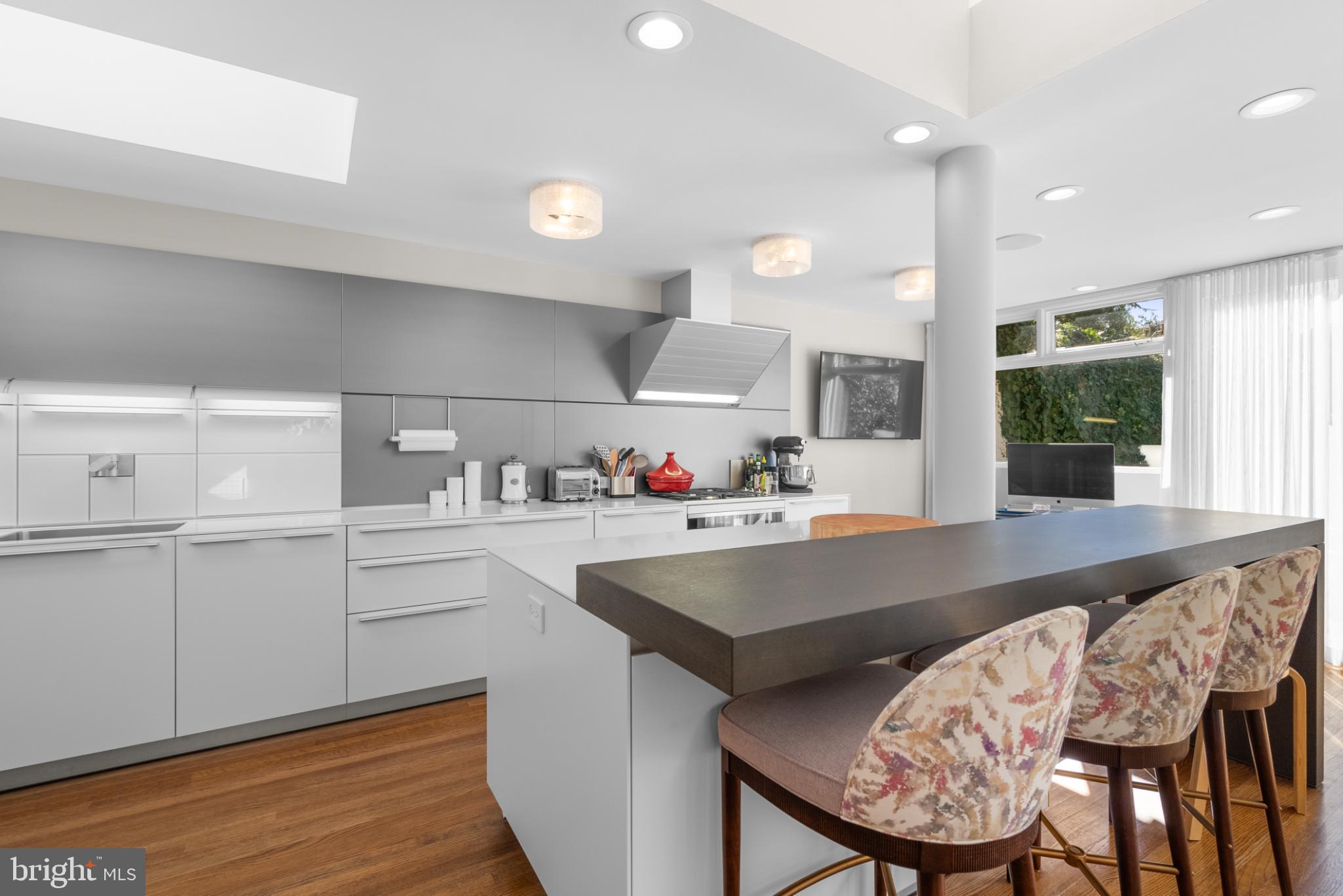 3322 Dent Place Northwest Washington, DC 20007 - Photo 10 of 41 a kitchen with a table chairs sink and cabinets