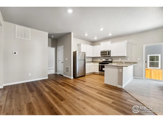 a view of kitchen with wooden floor