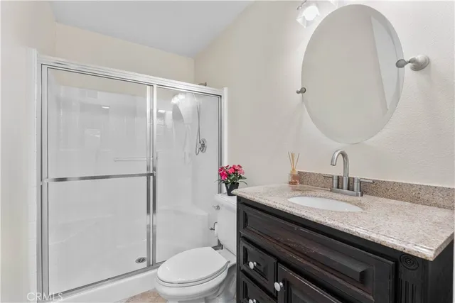 a bathroom with a sink vanity mirror and toilet