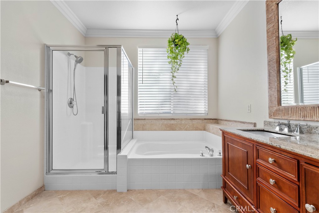1010 Night Shadow Lane Corona, CA 92881 - Photo 39 of 48 a bathroom with a tub sink and mirror