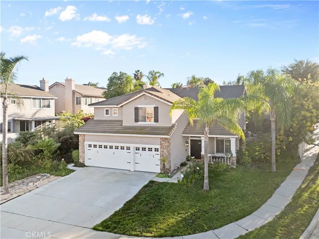 an aerial view of residential houses with outdoor space and trees