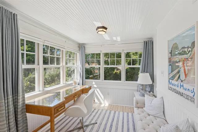 a living room with furniture and large windows