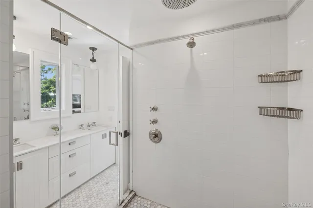a bathroom with a shower sink and mirror