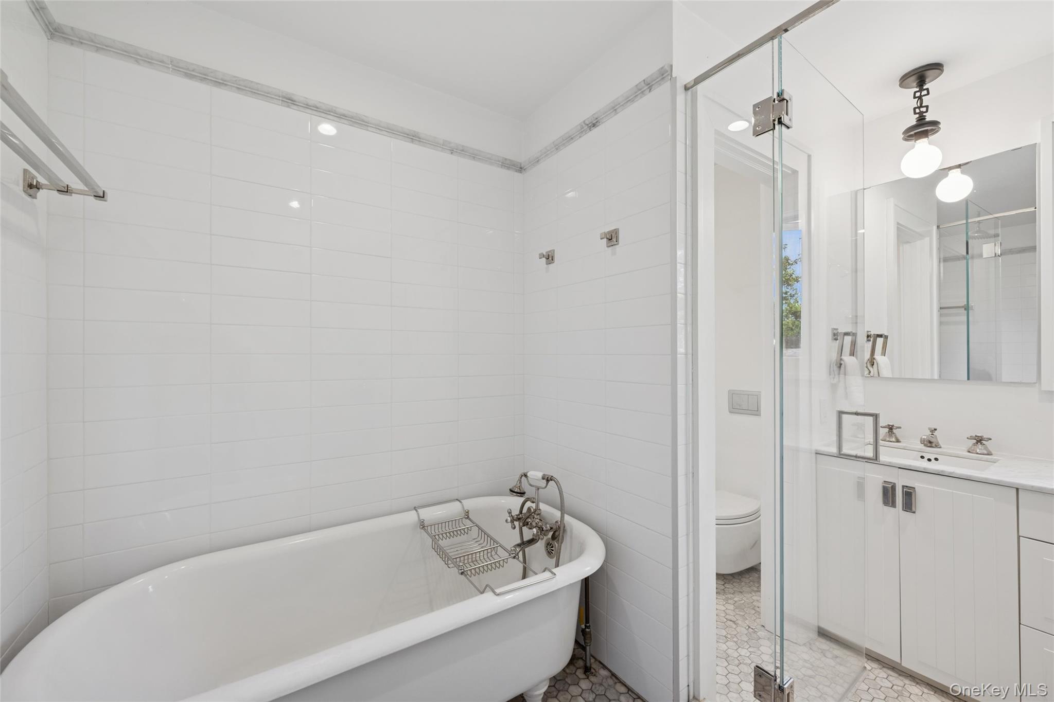 51 Sherrill Road East Hampton, NY 11937 - Photo 23 of 35 a bathroom with a tub a toilet and a sink