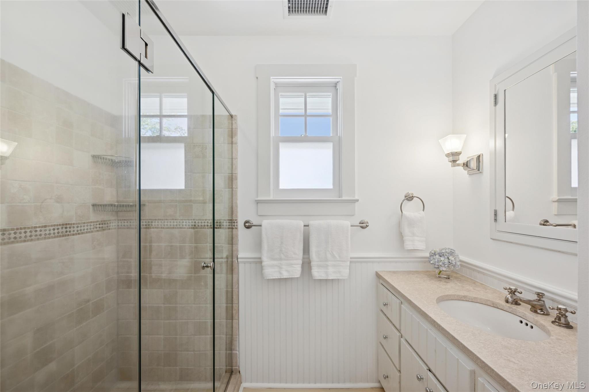 51 Sherrill Road East Hampton, NY 11937 - Photo 27 of 35 a bathroom with a granite countertop sink a mirror and shower