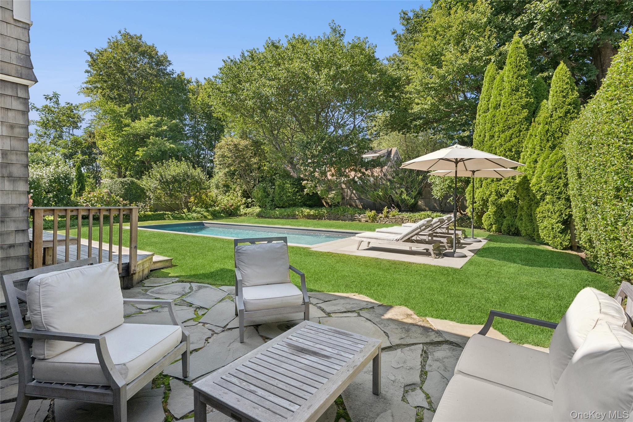 51 Sherrill Road East Hampton, NY 11937 - Photo 30 of 35 a view of a patio with furniture and a yard