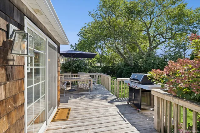 a view of a patio with table and chairs and wooden floor