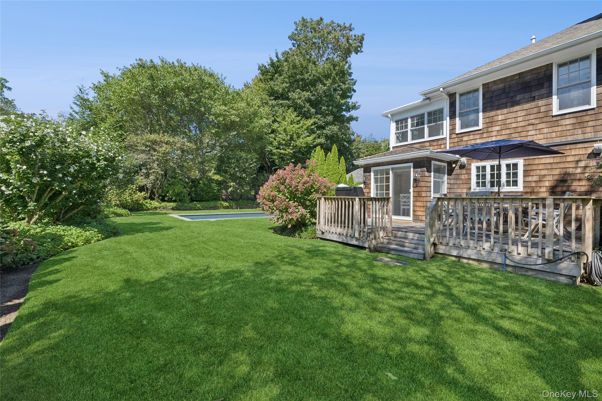 51 Sherrill Road East Hampton, NY 11937 - Photo 33 of 35 a view of a house with a yard and deck