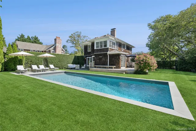 a front view of a house with a big yard