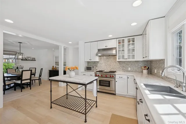 a kitchen with stainless steel appliances granite countertop a sink stove and cabinets