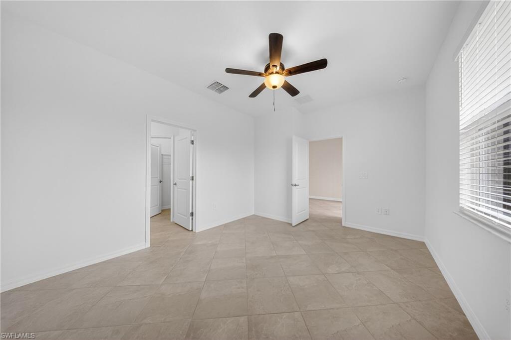 2220 Dragonfruit Way Naples, FL 34120 - Photo 11 of 31 Unfurnished bedroom with a ceiling fan and baseboards