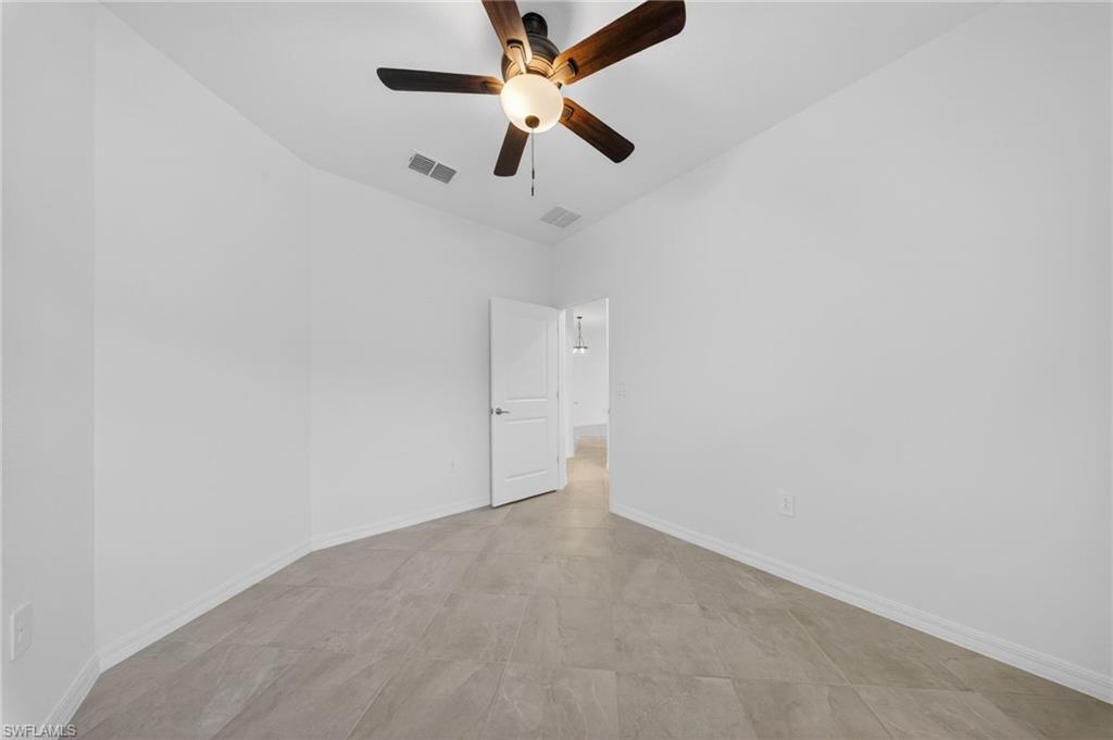 2220 Dragonfruit Way Naples, FL 34120 - Photo 15 of 31 Spare room featuring ceiling fan and baseboards