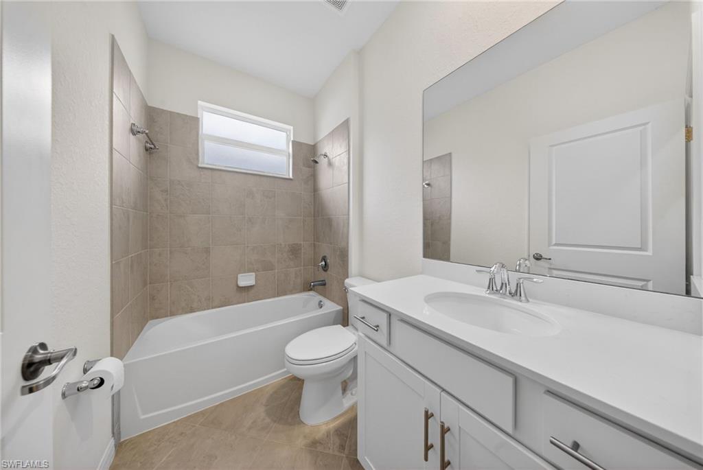 2220 Dragonfruit Way Naples, FL 34120 - Photo 17 of 31 Bathroom with vanity, shower / bathtub combination, and light tile patterned floors