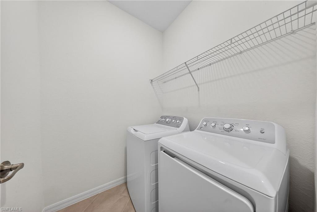 2220 Dragonfruit Way Naples, FL 34120 - Photo 20 of 31 Laundry room with baseboards and washing machine and dryer