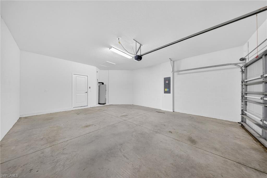 2220 Dragonfruit Way Naples, FL 34120 - Photo 24 of 31 Garage with electric panel and water heater