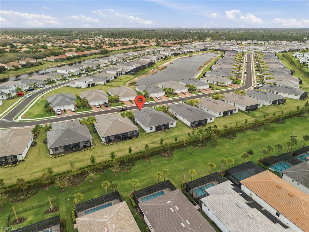 2220 Dragonfruit Way Naples, FL 34120 - Photo 27 of 31 Aerial view of property and surrounding area featuring nearby suburban area and a nearby body of water