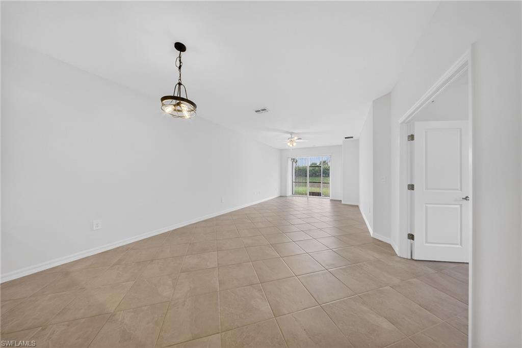 2220 Dragonfruit Way Naples, FL 34120 - Photo 6 of 31 Empty room with ceiling fan and light tile patterned floors