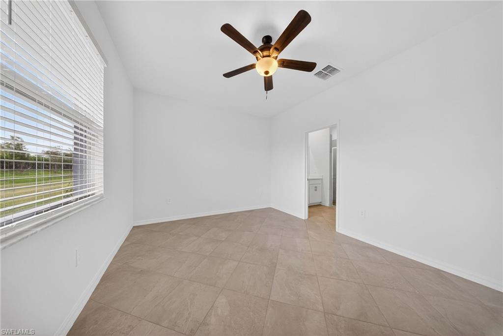 2220 Dragonfruit Way Naples, FL 34120 - Photo 9 of 31 Spare room with a ceiling fan and baseboards