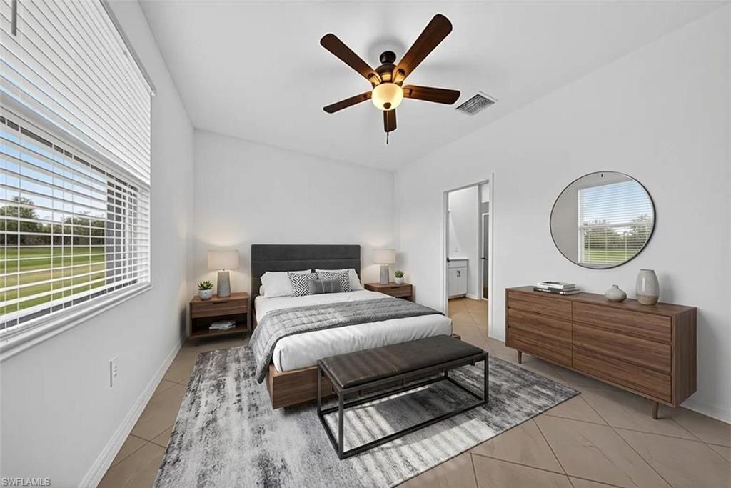 2220 Dragonfruit Way Naples, FL 34120 - Photo 10 of 31 Bedroom featuring light tile patterned flooring, a ceiling fan, and ensuite bathroom