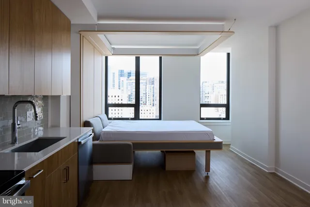 a dining room with a table chairs and chandelier