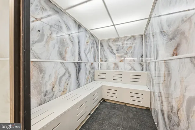 a bathroom with a double vanity sink toilet and a mirror