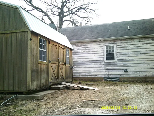 a view of a brick house with large windows