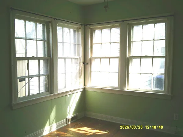 a room with a window and a ceiling fan