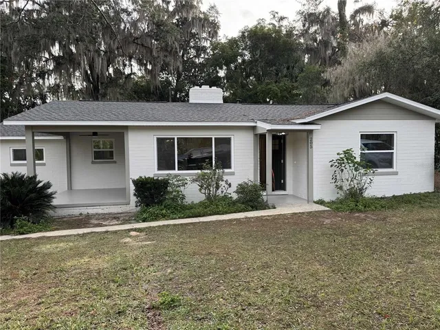 a front view of house with yard and trees