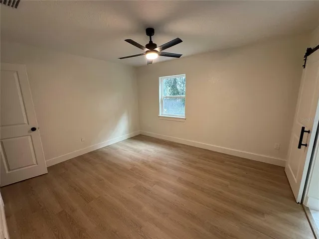 a view of an empty room and wooden floor