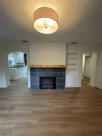 a view of an empty room and a fireplace