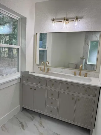 a bathroom with a double vanity sink and mirror